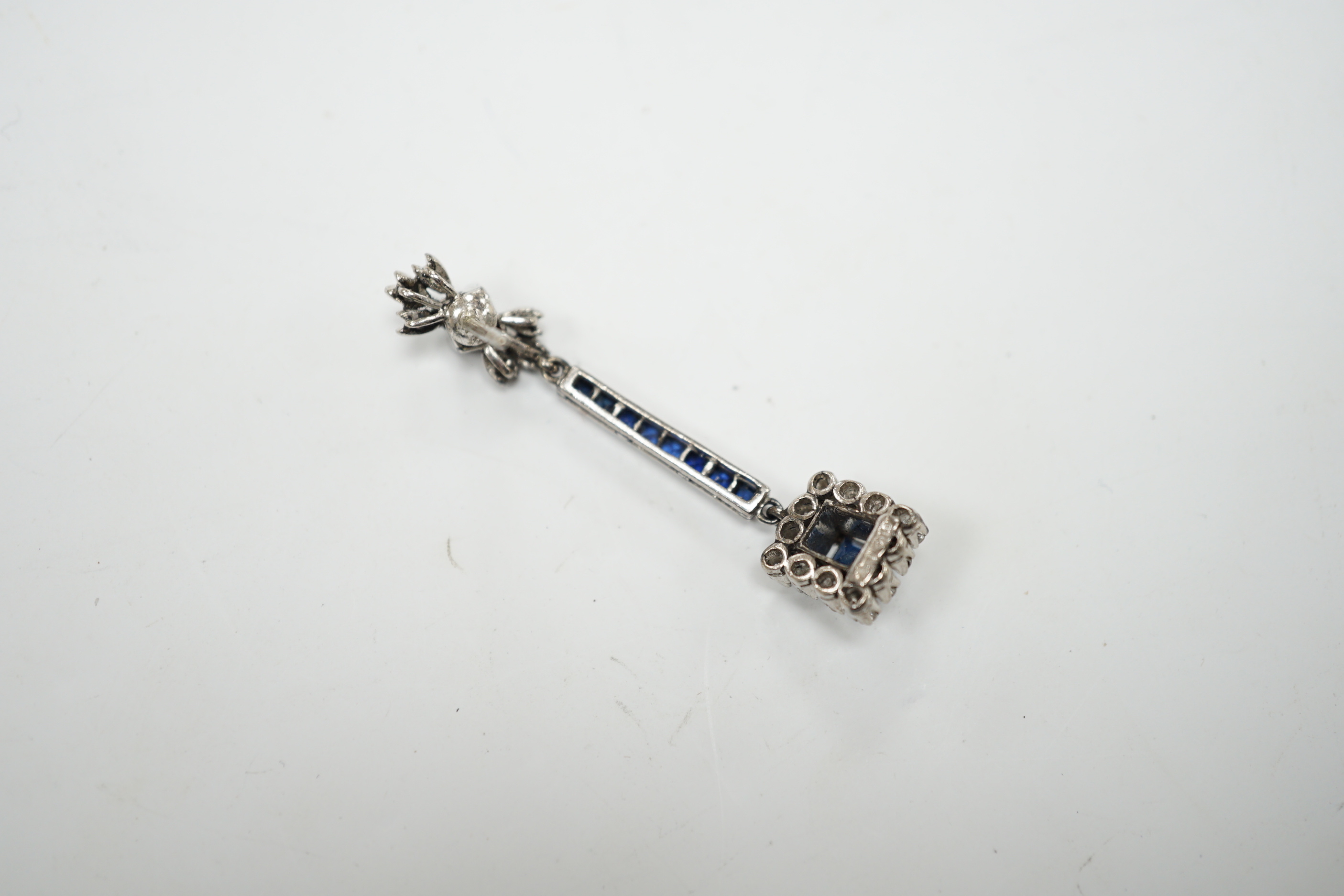 A single white metal (butterfly stamped 18), sapphire and diamond cluster set drop earring, 45mm, gross weight 4.1 grams.